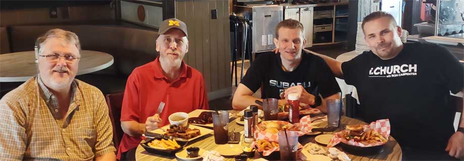 Four Alpha House transitional housing residents enjoying a Christmas in May lunch